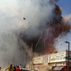 Rescue workers and residents flee as a fourth explosion sounds at a market area in downtown Celaya, Mexico, Sunday, Sept. 26, 1999. At least 56 people were killed when a series of explosions erupted, sparked by a supply of gunpowder used for making fireworks.